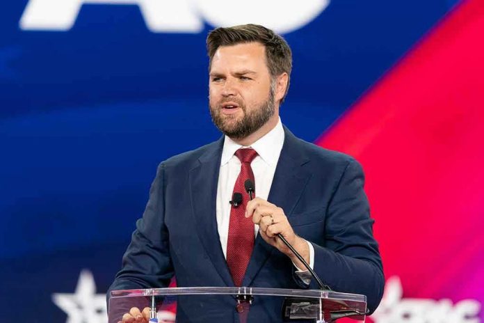 Man speaking at a podium, wearing suit and tie.