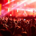 Music Icon’s Shocking Health Crisis Crowd at concert with vibrant stage lights.