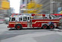 Lithium Batteries Ignite: DISASTROUS Bus Inferno! Red fire truck driving through city street crosswalk