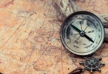 Vanished Picasso Masterpiece FOUND—Police Baffled! Old compass on a vintage map background.