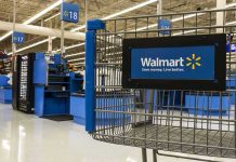 Walmart HALTS Program—Corporate America Shakes Walmart shopping cart inside store near checkout aisle