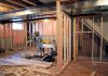 Interior of a basement under construction with wooden frames and tools