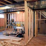 Interior of a basement under construction with wooden frames and tools