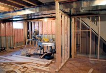 Interior of a basement under construction with wooden frames and tools