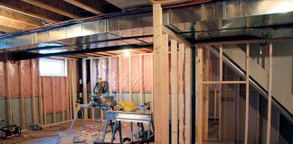 Interior of a basement under construction with wooden frames and tools