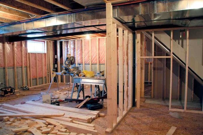 Interior of a basement under construction with wooden frames and tools