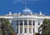 Trump Bulldozers East Wing—Regulators Frozen The White House with the American flag flying against a blue sky