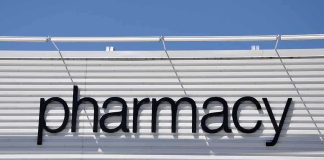 Sign displaying the word pharmacy against a white background