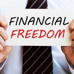 A man in a business suit holding a sign that says Financial Freedom