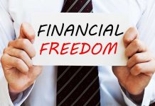 A man in a business suit holding a sign that says Financial Freedom