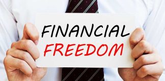 A man in a business suit holding a sign that says Financial Freedom