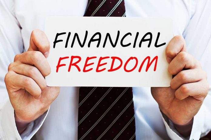 A man in a business suit holding a sign that says Financial Freedom