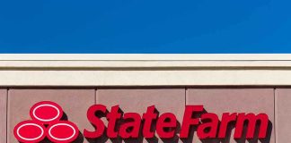 State Farm logo displayed on a building against a blue sky