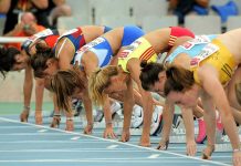 Female athletes preparing to start a race in track and field