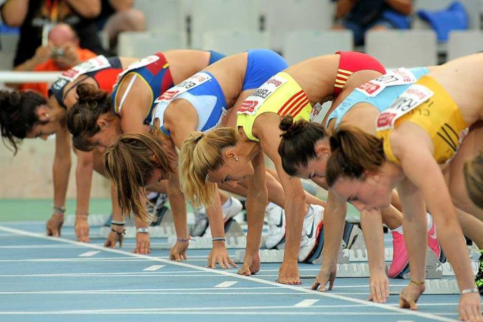 Female athletes preparing to start a race in track and field