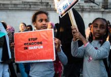 Siege Horror Stuns Darfur — 260,000 STARVING! Children holding signs at a protest against Darfur genocide.