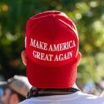 Spy Meeting RIPS MAGA – Loyalty Shattered Person wearing a red Make America Great Again hat.
