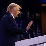 Trump Drops Kazakhstan Bombshell—World Leaders Stunned Person speaking at a podium with hand raised