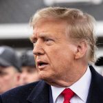 Epstein Files Shock: Trump Advisors PANIC! Man in suit and red tie speaking outside.