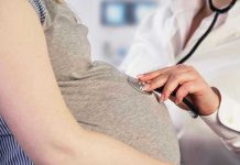 Woman Suffers Miscarriage – Felony Charge Follows? Doctor uses stethoscope on pregnant womans belly.