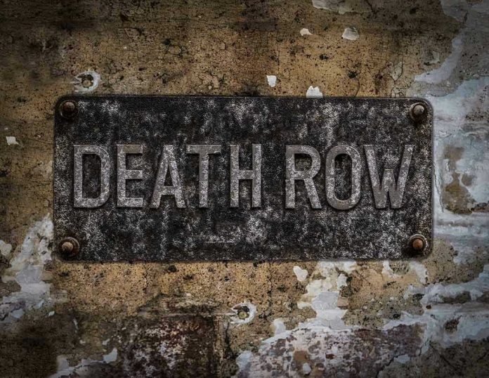Weathered Death Row sign on aged concrete wall
