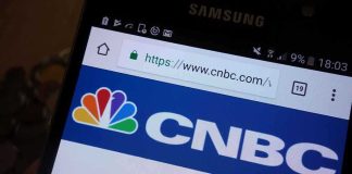 Close-up of a smartphone displaying the CNBC website