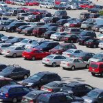 A crowded parking lot filled with various cars
