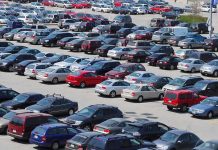 A crowded parking lot filled with various cars