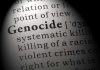 Close-up of the word 'Genocide' in a dictionary with its definition