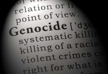 Close-up of the word 'Genocide' in a dictionary with its definition