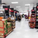 Interior of a grocery store with shelves filled with products and shoppers