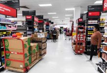 Interior of a grocery store with shelves filled with products and shoppers