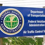 Shutdown CHAOS: Flights Grind to Halt Nationwide Sign for the Federal Aviation Administration at an air traffic control tower