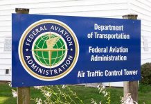 Shutdown CHAOS: Flights Grind to Halt Nationwide Sign for the Federal Aviation Administration at an air traffic control tower