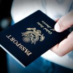 Trump Mandate Upends Travel—NEW Passport Requirements A person holding a United States passport with a dark background