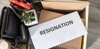 Envelope labeled resignation in a box of office items.