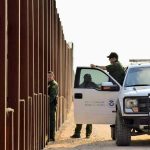 Trump’s Deportation Team DIVIDED – What’s Happening? Border patrol agents near a tall metal fence.