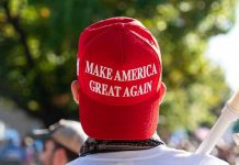 MASSIVE Betrayal – Trump Support Base Turn Person wearing a red Make America Great Again hat.