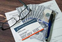Medicaid Pays DEAD People Billions – Fraud Scandal! Medicare card glasses pen money on wooden table