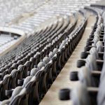 Iconic Sports Stadium BURNS – 145 Years GONE Empty rows of gray seats in a stadium.