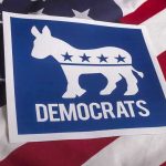 Disgraced Dem Launches Comeback – Announces Governor Bid Democrats logo on American flag background