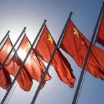 China Purchases 500 US Schools – Taking Over Red flags with yellow stars on flagpoles.