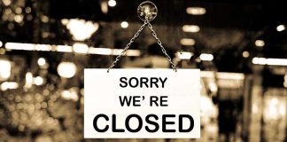 Closed sign hanging in a shop window.