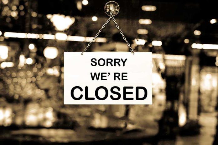 Closed sign hanging in a shop window.