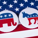 Candidate’s LAst-Minute Party Flip Shocks Democrat Donors Republican elephant and Democrat donkey on American flag.