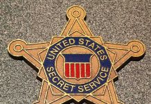 Golden badge of the United States Secret Service displayed on a surface