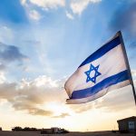 Eurovision Boycott ERUPTS – Major Countries PULL OUT! Israeli flag waving against a sunset backdrop with clouds