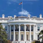 Pop Star’s Lyrics Hijacked – Sparks White House FEUD! The White House with the American flag flying against a blue sky