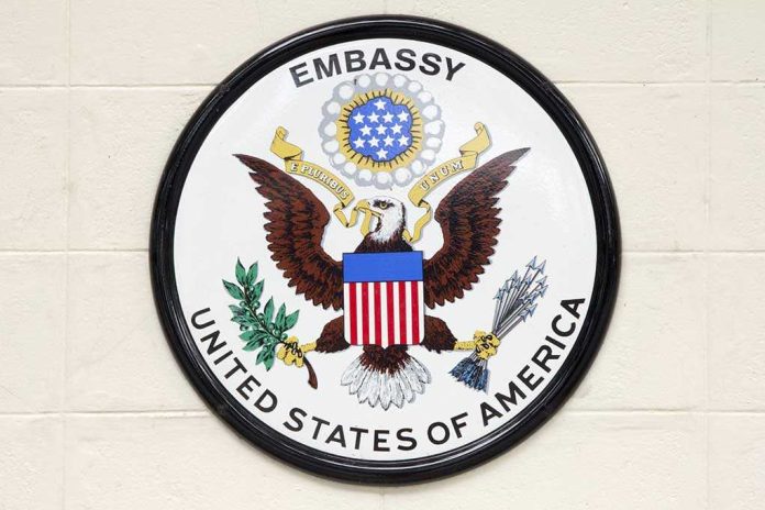 Seal of the United States Embassy featuring an eagle and the American flag