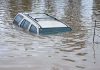 Catastrophic Floods Trap 100,000 – Governor Desperate for Help! A partially submerged vehicle in floodwaters